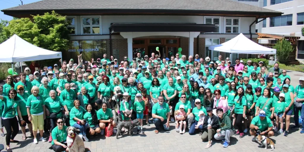 Group photo of all Hike participants in green t-shirts taken at Hike for Hospice in 2024.