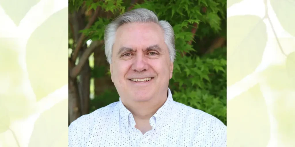 Portrait of Dr. Louie Mavrogiannis with greenery in the background